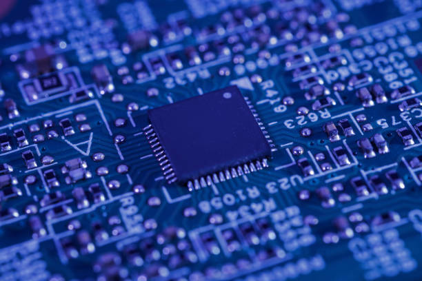 istock Close-up view of an integrated circuit mounted on a green printed circuit board. 2152127638