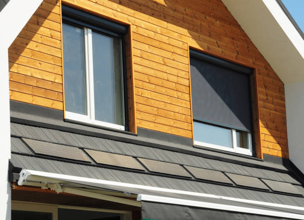 istock Retractable Sun Shades and Solar Screens on attic windows. Retractable Solar Screens and modern wooden house facade with retractable awnings. 2152130305