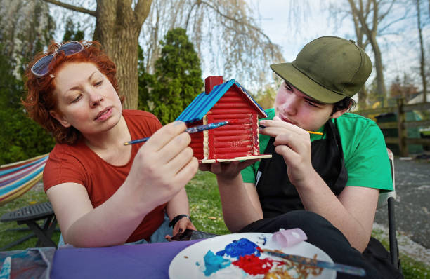 istock Mother and son painting birdhouse 2152134145
