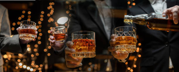 istock Barman pouring whiskey whiskey glass beautiful night 2152134813