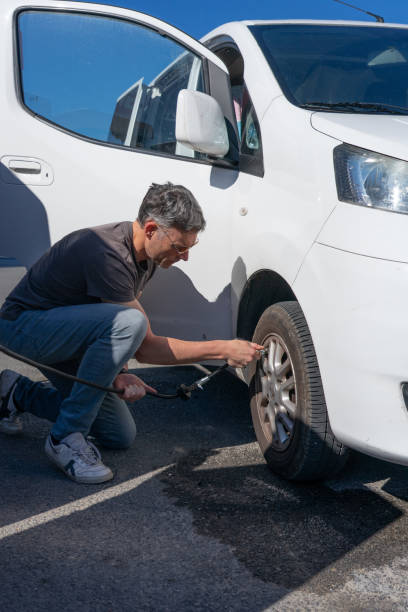 istock Man inflating the tires of his camper van before a trip 2152135876
