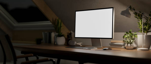 istock Contemporary minimalist home office workspace in the attic room at night features a computer mockup 2152136103