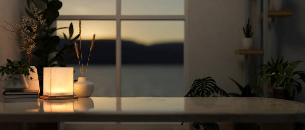 istock A copy space on a coffee table with dim light from a lamp in a contemporary living room at night. 2152136628