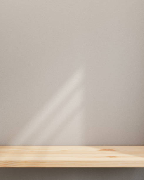 istock A minimal wooden board or tabletop for displaying products is set against the white wall. 2152136718