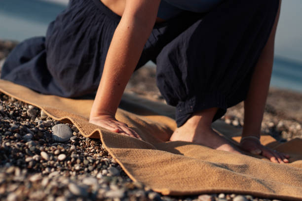 istock of young woman doing exercises on the sea beach 2152136881