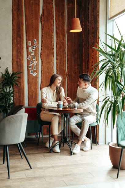 istock Young Couple Enjoying a Coffee Date at a Cozy Cafe During Afternoon Hours 2152137417