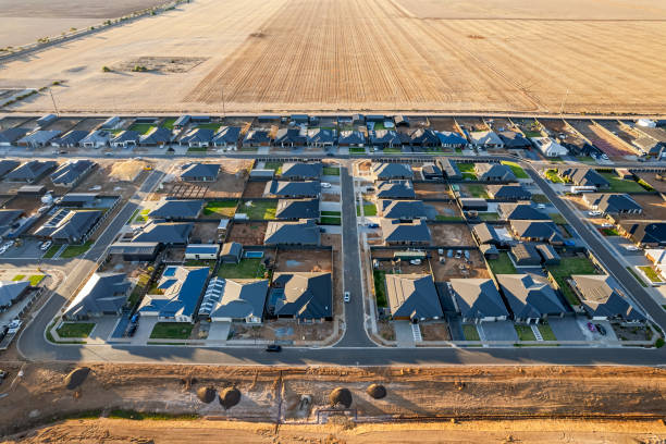 istock Aerial view urban sprawl encroaching on arable agricultural land at sunset 2152137419