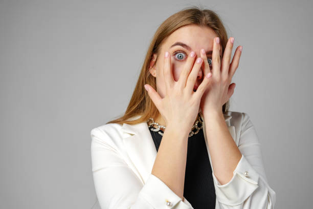 istock Young Woman Covering Her Eyes With Hands 2152139091