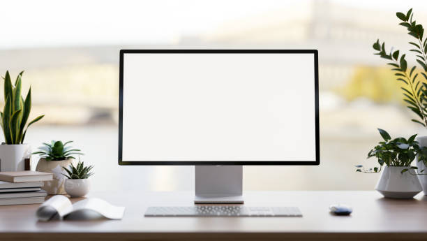 istock A computer white-screen mockup, a keyboard, books, and potted plants on a desk against the window. 2152139312