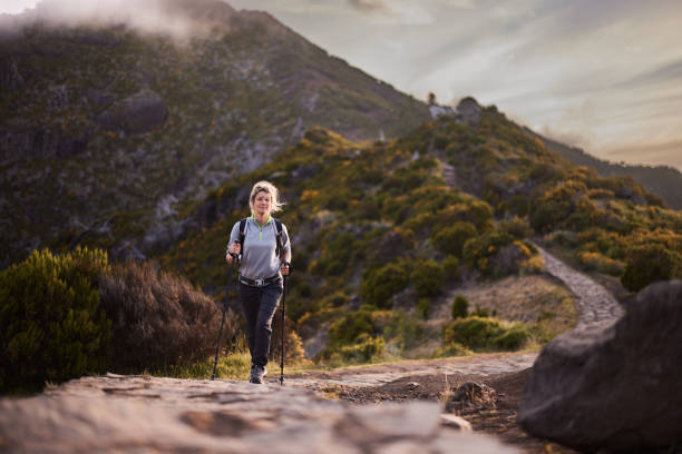 istock Smiling female backpacker hiking on a mountain. 2152139623