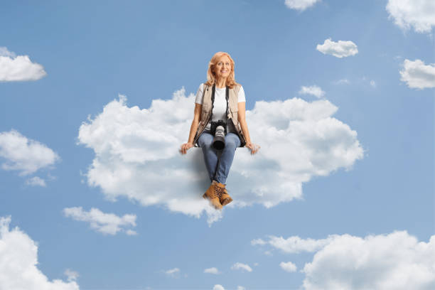 istock Female photo reporter sitting on a cloud 2152139798