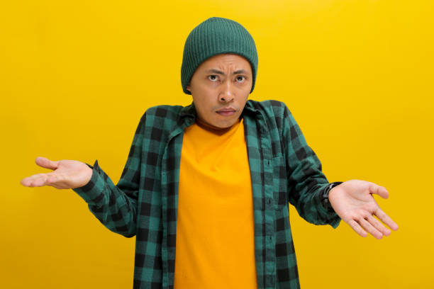 istock Young Asian man is making an I don't know Italian gesture, with open arms, raised shoulders 2152139837