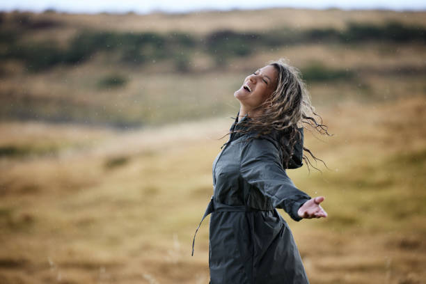 istock Cheerful woman having fun on a rain in nature. 2152139889