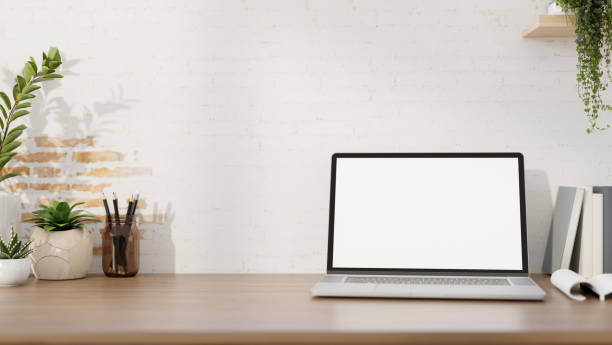 istock A minimalist workspace features a laptop computer mockup on a desk against the white brick wall. 2152139991