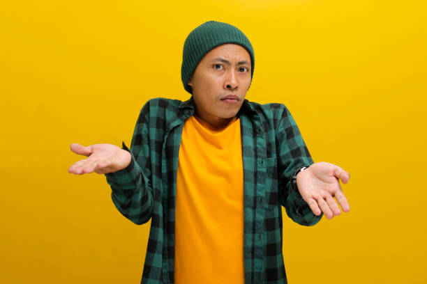 istock Young Asian man is making an I don't know Italian gesture, with open arms, raised shoulders 2152140006