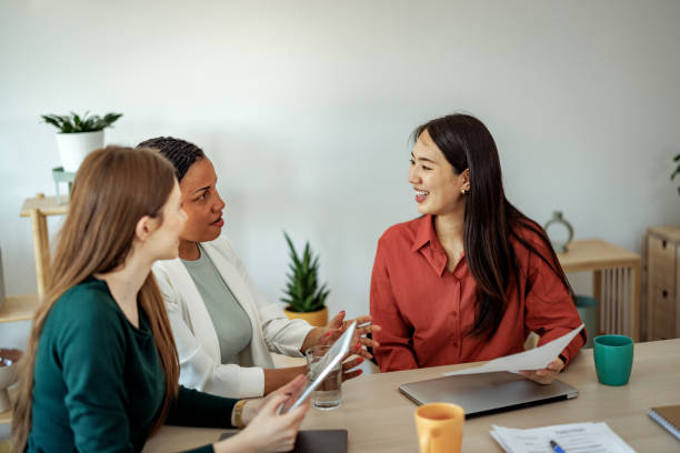 istock Cheerful female colleagues discussing work at the office 2152142255