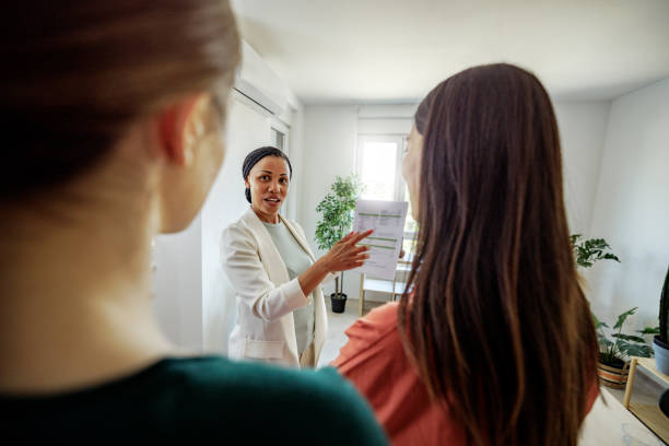 istock Well dressed businesswoman showing paperwork while talking with her colleagues at the office 2152142282
