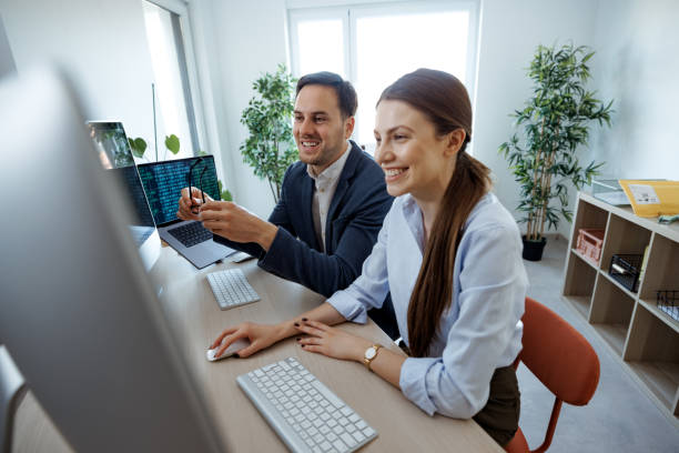 istock Two well dressed business people cooperating at the modern office 2152142410
