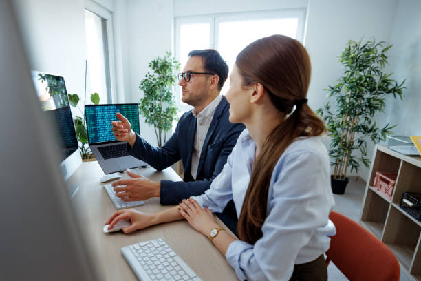 istock Well dressed business duo working at the small office together 2152142413