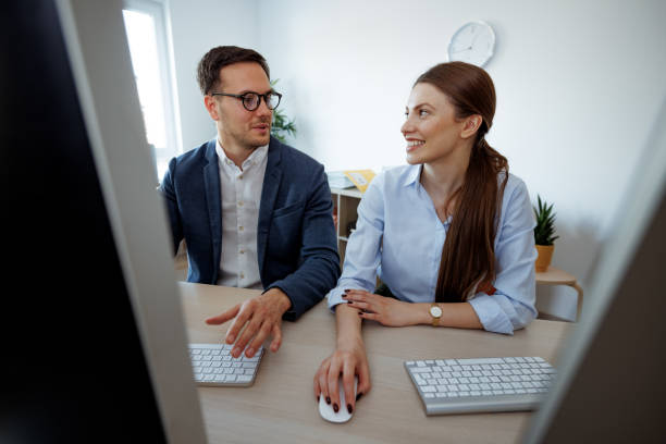 istock Well dressed business duo working at the small office together 2152142431