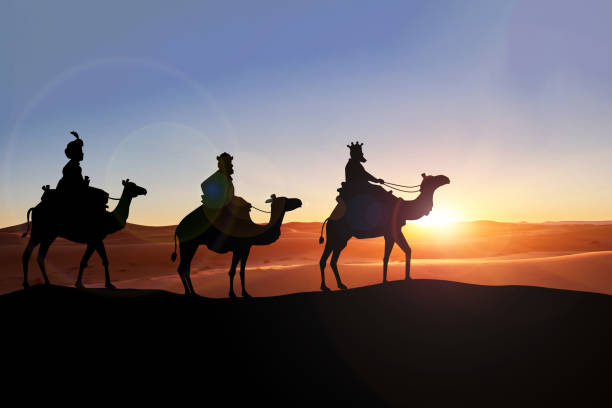A serene silhouette of a camel caravan traverses a desert dune against a vibrant sunrise backdrop, capturing the essence of adventure and travel in the wilderness.
