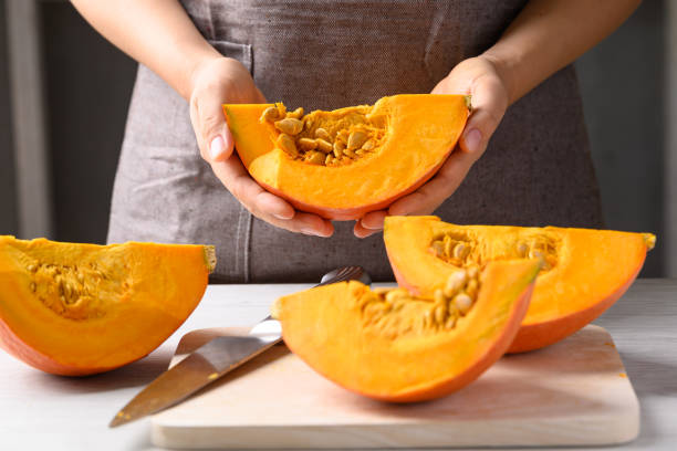 istock Orange Hokkaido pumpkin with hand prepare for cooking 2152144301