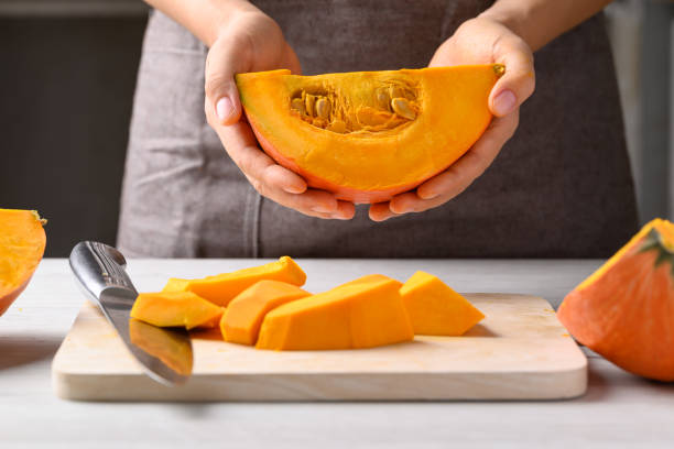 istock Orange Hokkaido pumpkin with hand prepare for cooking 2152144870