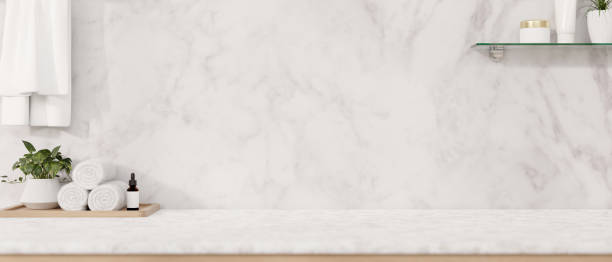 istock A modern luxurious white marble bathroom tabletop features a toiletry set, towels, and a space. 2152145022