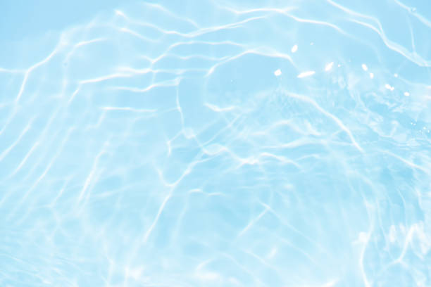 istock Blue water with ripples on the surface. Defocus blurred transparent blue colored clear calm water surface texture with splashes and bubbles. Water waves with shining pattern texture background. 2152145259