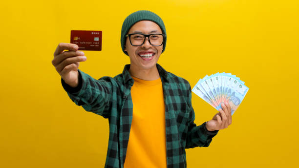 istock Man with Credit Card & Cash 2152145544