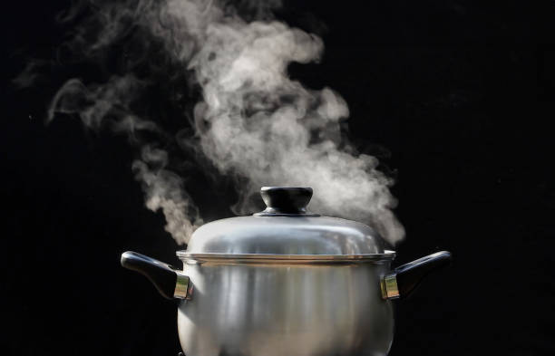 istock steam over cooking pot in kitchen on dark background 2152146149