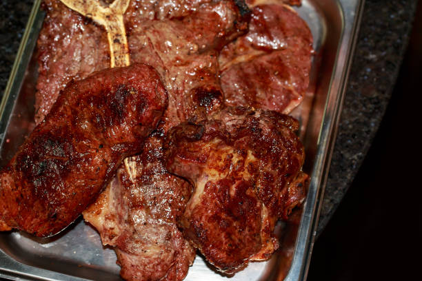 cooked porterhouse loin steak close-up in a metal plate