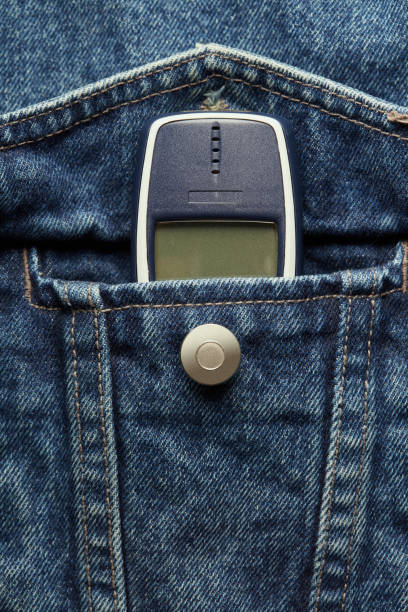 istock Old-fashioned push-button phone inside of denim jcket's pocket 2152147396