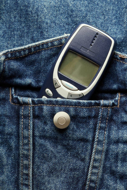 istock Old-fashioned push-button phone inside of denim jcket's pocket 2152147397