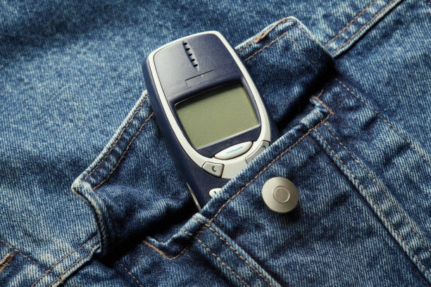 istock Old-fashioned push-button phone inside of denim jcket's pocket 2152147398