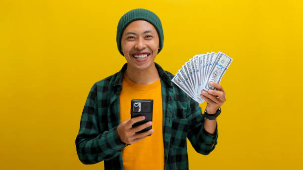 istock Excited for What's Next, Man with Phone & Money 2152147769