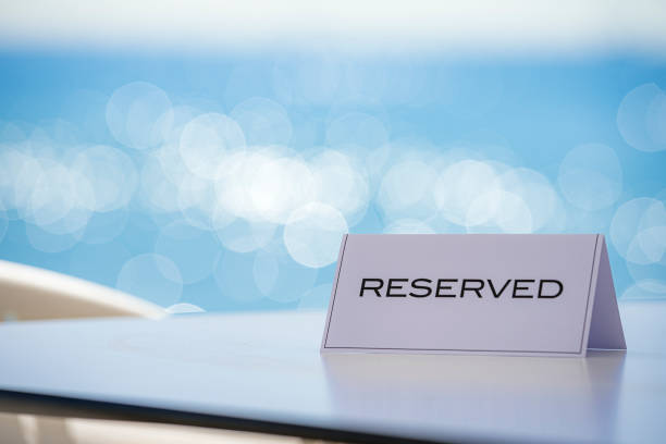 Restaurant reservation sign on white table by the beach. High resolution 42Mp outdoors digital capture taken with Sony A7rII and Canon EF 70-200mm f/2.8L IS II USM Telephoto Zoom Lens