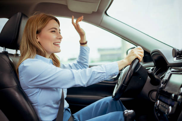 istock Woman on Driver Seat Singing Song While Driving 2152151550