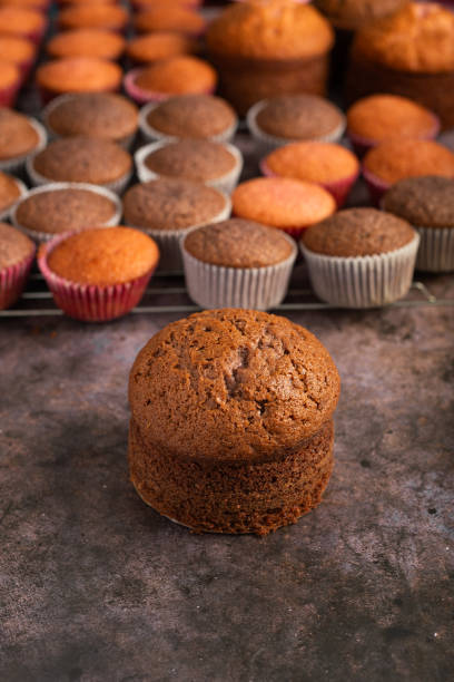 istock Small freshly baked cake and cupcakes in the background. Pastry table. 2152151956