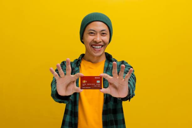 istock Happy young Asian man shows a credit card 2152153173