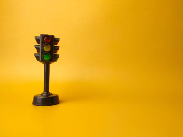 istock Mini traffic lights traffic lights toy on a yellow background 2152153609