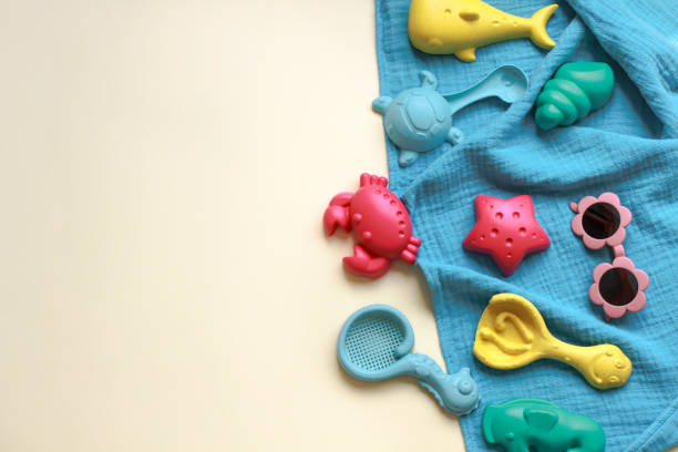 Sand molds beach toys for kids on beige background with copy space. Top view. Summer and vacation concept