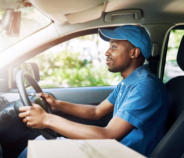 istock Delivery, black man and box as courier service in transportation for cargo shipping, ecommerce or distribution. Male person, vehicle and online shopping order or logistics worker, parcel or mail 2152157808