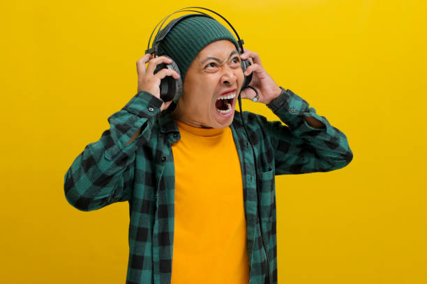 istock Music Mayhem: Annoyed Man with Headphones 2152159291