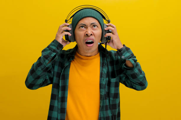 istock Music Mayhem: Annoyed Man with Headphones 2152159408