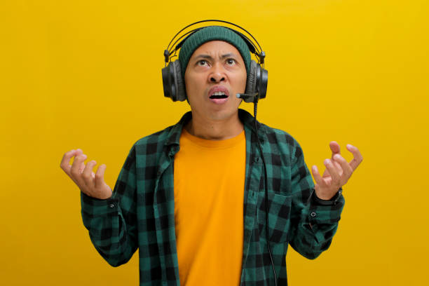 istock Music Mayhem: Annoyed Man with Headphones 2152159985
