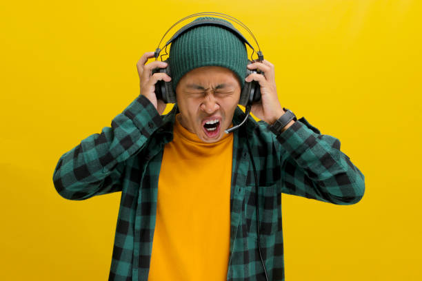 istock Music Mayhem: Annoyed Man with Headphones 2152159987