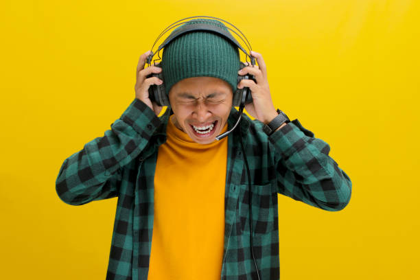 istock Music Mayhem: Annoyed Man with Headphones 2152160058