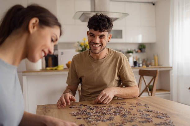 istock Happy couple enjoying in jigsaw puzzle at home. 2152160657