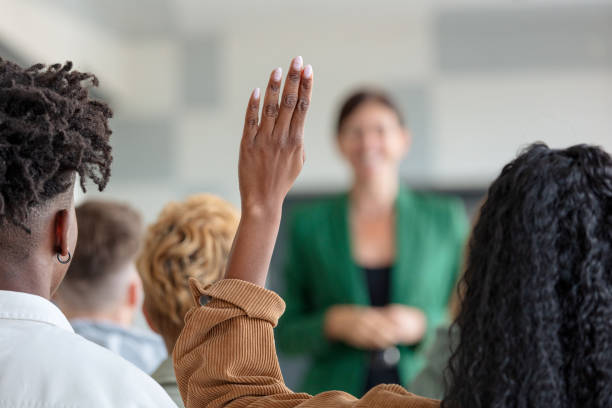 Female teacher giving presentation to university students